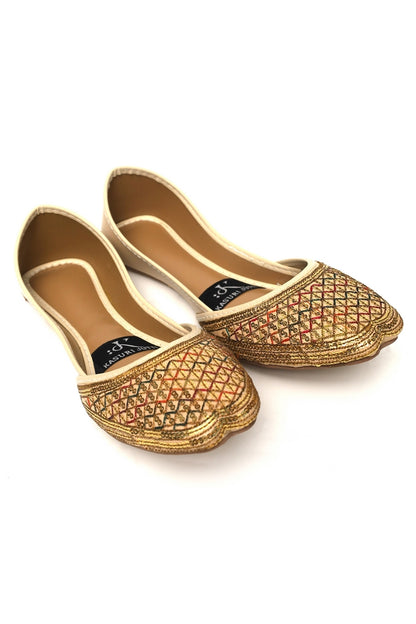 Pair of gold embroidered Desert Diamond Kasuri Jutti on a white background, front angle