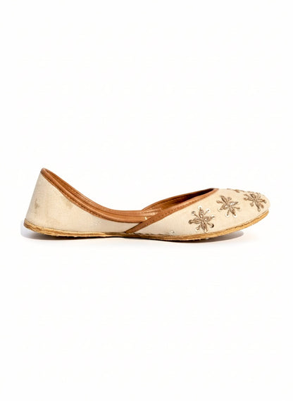 Tilla Work Kasuri Jutti with floral embroidery on a white background