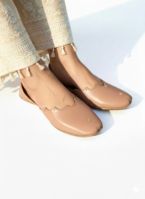 Beige Kasuri jutti worn on feet with cream trouser