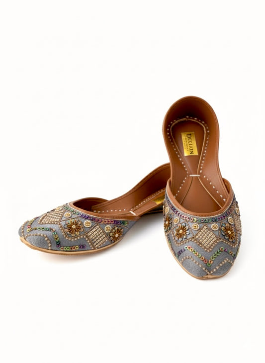 Close view of grey Kasuri jutti pair with golden work