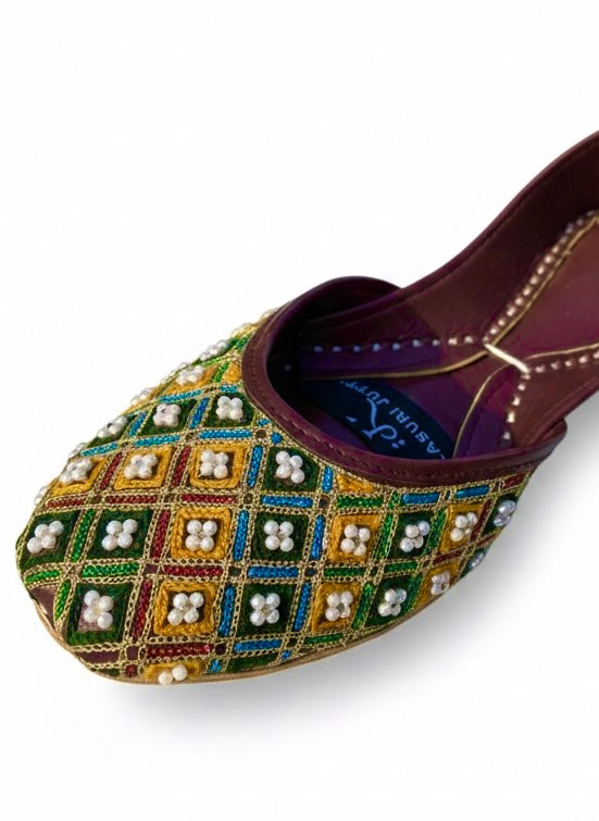 Close view of multi color Kasuri jutti with pearl and stone beads