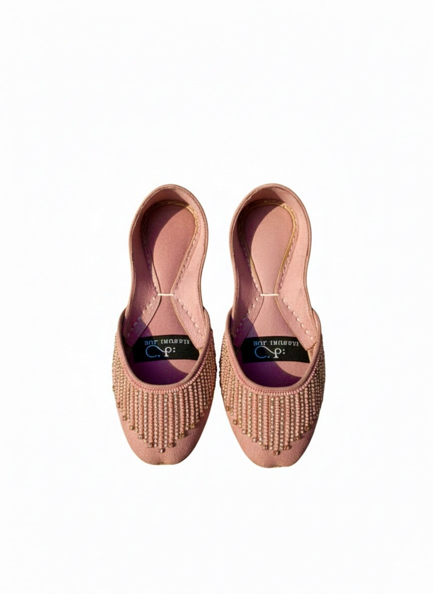 Top view of pink Kasuri jutti pair with bead flower design