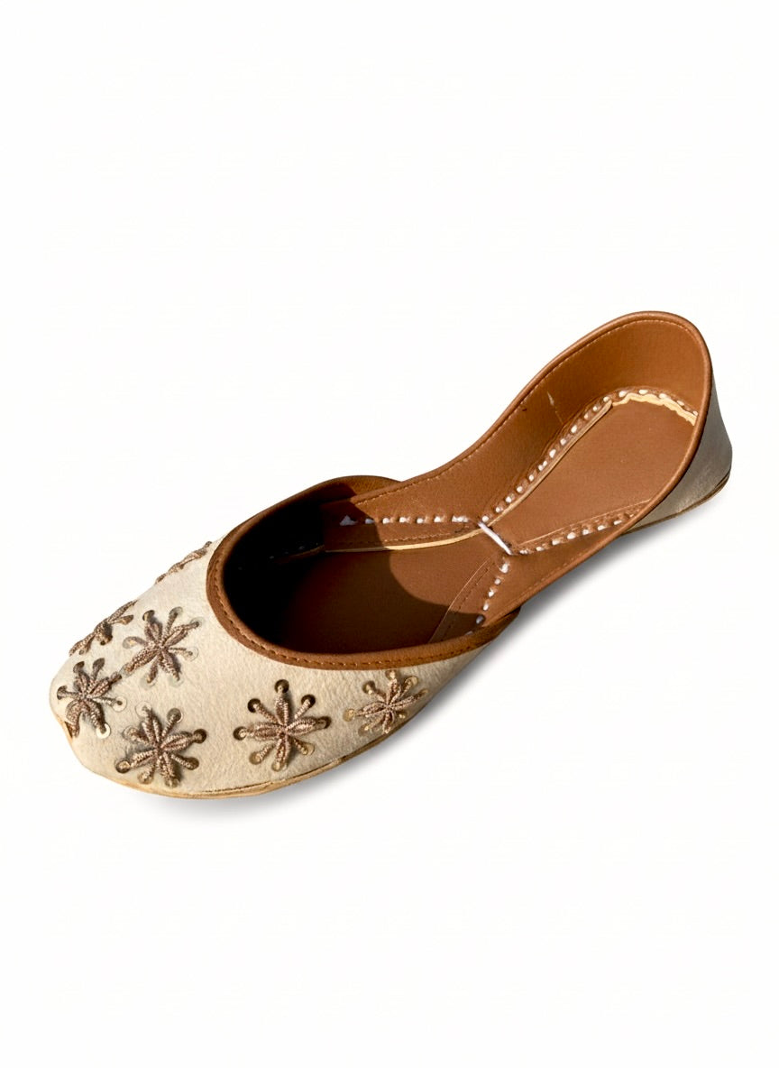Cream Kasuri jutti with beautiful gold tilla flower design, top view